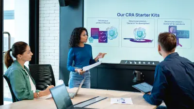 The image depicts two colleagues discussing about cybersecurity compliance and standards