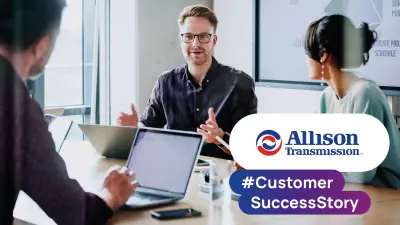 People collaborating in a meeting room with laptops, accompanied by Allison Transmission customer success story branding.