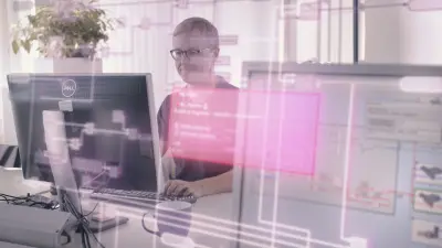 The image shows a man sitting in front of a PC, coding an ECU software application. The picture has an overlay of an image of the EHANDBOOK software.